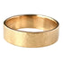 A hammered yellow gold band ring resting on a light gray marble surface.